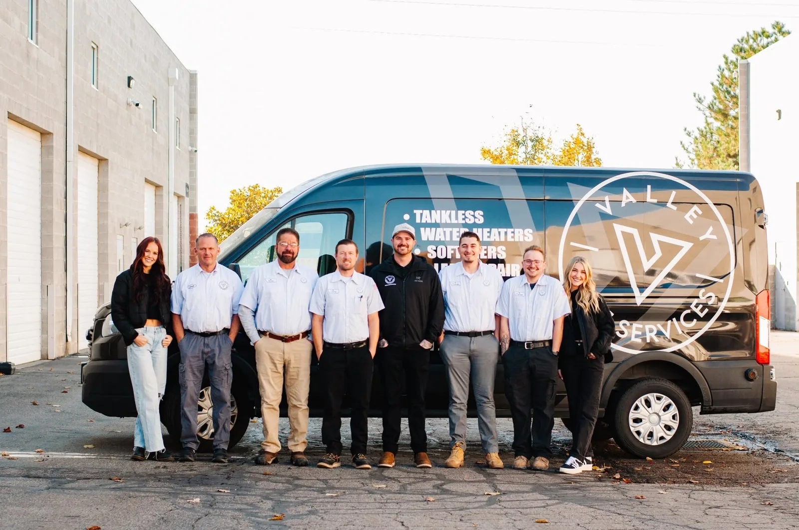 Salt Lake and Eagle Mountain Valley Home Services plumbers in front of the company van